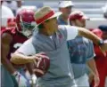  ?? AP PHOTO/BUTCH DILL ?? Alabama head coach Nick Saban throws a pass during a NCAA college football practice Aug. 4in Tuscaloosa, Ala.