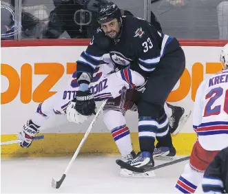  ?? MARIANNE HELM/ GETTY IMAGES ?? Dustin Byfuglien of the Winnipeg Jets does a number on the back of New York Rangers’ Mats Zuccarello during NHL action Tuesday night in Winnipeg. Byfuglien faces a suspension after cross- checking R. T. Miller from behind later in the game.