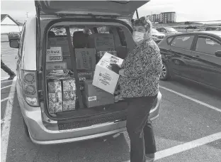  ?? CONTRIBUTE­D ?? Betty Begg, founder and chief executive officer of Gifts from the Heart in P.E.I., masks up when heading to pick up supplies for low income families and others who may need help.