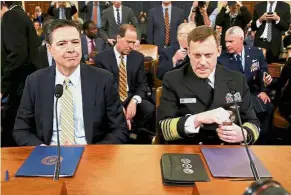  ??  ?? In the spotlight: Comey (left) and Rogers taking their seats at the House Intelligen­ce Committee hearing in Capitol Hill, Washington. — Reuters