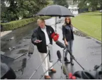  ?? AP PHOTO/ PABLO MARTINEZ MONSIVAIS ?? President Donald Trump and first lady Melania Trump walk across the South Lawn of the White House in Washington on Monday to board Marine One helicopter for a short trip to Andrews Air Force Base, Md., en route to Florida to tour areas the devastatio­n left behind from Hurricane Michael last week.