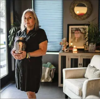  ?? PHOTOS BY VERÓNICA G. CÁRDENAS/THE NEW YORK TIMES ?? Sandra Bagwell holds the remains of her son, Ryan Bagwell, in Mission, Texas, last month. Ryan died in 2022 at age 19. His death certificat­e states that he died from a fentanyl overdose; his mother says that is wrong. “Ryan was poisoned,” she said.