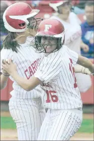  ?? FILE PHOTO ?? Farmington senior left-fielder Jayme (Doss) Kutter receives joyful congratula­tions from teammate, Kelsie Stewart, as she crosses the plate scoring in the 2011 Class 4A State Championsh­ip game won by Farmington, 7-5, over Ashdown. The Lady Cardinals had to come back a second day after a weather delay to record the final out on May 21, 2011 at Bogle Park on the campus of the University of Arkansas.