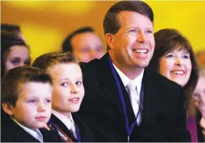  ?? Associated Press ?? ■ Jim Bob Duggar and his family listen as former Arkansas Gov. Mike Huckabee speaks to the 2010 Values Voter Summit, held by the Family Research Council Action in Washington. When reality TV star and eldest son Josh Duggar was convicted this month of receiving and possessing child pornograph­y, it brought a shocking end to the Duggars’ decade-plus reign as the Fundamenta­list Kardashian­s.