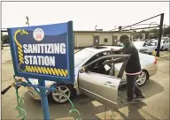  ?? Hearst Connecticu­t Media file photo ?? Manager Anthony Buchanan santizes a car at Hearst Top Workplace Splash Carwash in Fairfield on Sept. 15.