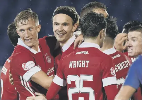  ??  ?? 0 Aberdeen’s Ryan Hedges, centre, celebrates his match-winning goal against St Johnstone with new signing Ross Mccrorie, left.