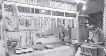  ?? ?? Samuel Juridico, with a stall at the Pavia Public Market, sells pork at P400 per kilo.