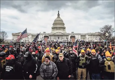  ?? Jon Cherry/Getty Images / TNS ?? A pro-Trump mob gathers in front of the U.S. Capitol Building on Jan. 6 in Washington, D.C.