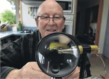  ?? PHOTO: GREGOR RICHARDSON ?? Weapon of war . . . Otago Fish & Game president Monty Wright prepares an ‘‘olive streamer’’ in readiness for his 66th season battling brown trout.