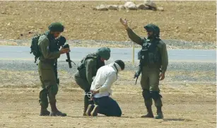  ?? (Ayman Nobani/Reuters) ?? SOLDIERS detain a Palestinia­n rioter yesterday near the West Bank town of Tubas.