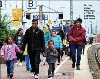  ??  ?? On the move: Migrants arrive in Germany last week