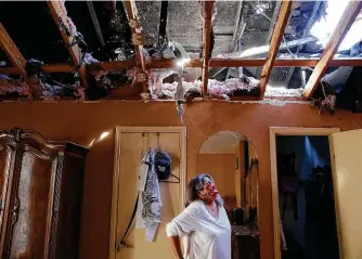  ?? Photos by Kin Man Hui / Staff photograph­er ?? San Juana Leahman looks at the damage in her bedroom of her home of 21 years that caught fire during last week’s winter storm. “I felt like my house was in pain,” she said through tears. “I love my house.”