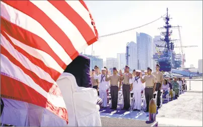  ?? NELVIN C. CEPEDA U-T ?? On board the USS Midway Museum on Friday, 20 military service men and women take part in the naturaliza­tion oath of allegiance and become U.S. citizens. It was one of 140 such ceremonies nationally celebratin­g Independen­ce Day.