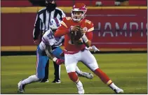  ?? JEFF ROBERSON — THE ASSOCIATED PRESS ?? Kansas City quarterbac­k Patrick Mahomes scrambles up field ahead of Buffalo defensive end AJ Epenesa during the AFC Championsh­ip.