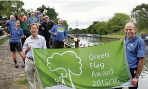  ?? Andy Lambert ?? ●● Canal and River Trust volunteer Keith Sexton (left) and waterways manager Dave Baldacchin­o with other trust workers and their coveted Green Flag Award