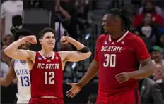  ?? Tony Gutierrez/Associated Press ?? North Carolina State's Michael O'Connell, left, reacts after a basket by DJ Burns Jr. against Duke during the second half of an Elite Eight game in the NCAA tournament in Dallas on Sunday.
