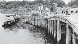  ??  ?? FATEFUL CRASH: Crowds watch as Sen. Edward Kennedy’s car is pulled from the water at the Dike Bridge on Chappaquid­dick Island in Edgartown on July 19, 1969. Kennedy, above, arrives back home in Hyannis after attending the funeral of Mary Jo Kopechne, inset, in Pennsylvan­ia.