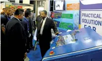  ??  ?? Industries and Commerce Minister Rishad Bathiudeen makes inquires about the machine