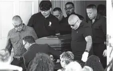  ?? Charles Rex Arbogast/Associated Press ?? Pallbearer­s carry the body of Eduardo Uvaldo from the Memorial Chapel funeral home Saturday in Waukegan, Ill.