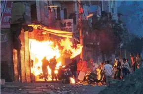  ?? PHOTO: PTI ?? ( Top) Rioters during a clash on Tuesday in Northeast Delhi, where fresh violence erupted between people demonstrat­ing for and against the new citizenshi­p law. Protesters set afire a shop