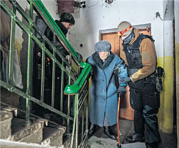  ?? ?? Alexandra Zhytnik, 92, is taken from her home in Chasiv Var by Finnish volunteers as Russian forces in Ukraine’s Donbas region close in on the nearby city of Bakhmut