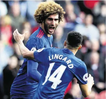  ??  ?? HERE WE GO: Marouane Fellaini celebrates with Jesse Lingard after opening the scoring