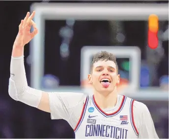  ?? ASSOCIATED PRESS ?? UConn center Donovan Clingan celebrates after hitting a 3-pointer against Illinois during Saturday’s NCAA Tournament Elite 8 game in Boston.