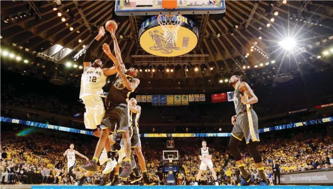  ??  ?? OAKLAND: LaMarcus Aldridge #12 of the San Antonio Spurs shoots the ball against the Golden State Warriors in Game Two of Round One of the 2018 NBA Playoffs on Monday at ORACLE Arena in Oakland, California. — AFP