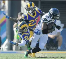  ?? MARK J. TERRILL/THE ASSOCIATED PRESS ?? Seahawks receiver Doug Baldwin breaks away from Rams defensive back John Johnson and cornerback Nickell Robey-Coleman on Sunday in Los Angeles. Seattle won 16-10.