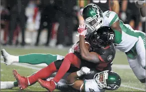  ?? CP PHOTO JUSTIN TANG ?? Saskatchew­an Roughrider­s linebacker Jeff Knox Jr. (49) drags down Ottawa Redblacks running back William Powell (29) during second half CFL football action in Ottawa on Friday.