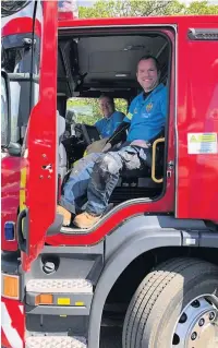  ??  ?? Ben Whiteley and James Hogben get a look inside a visiting fire engine