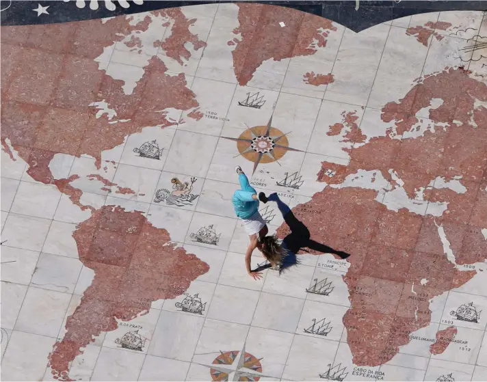  ?? ?? A dancer performs at the Monument to the Discoverie­s by the Tagus river in Lisbon, on Sunday, April 23, 2023. The 14 meter wide planispher­e showing the Portuguese sea routes of the 15th and 16th centuries decorating the monument square ground was gifted by South Africa. Photo : AP/Armando Franca.