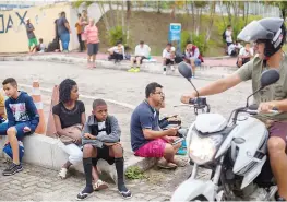  ?? — AFP photo ?? Youngsters and their relatives wait for the start of a football trial known as “Peneira” in Portuguese, in which they play under the watch of scouts from one of Brazil’s biggest clubs, Vasco da Gama, in northern Rio de Janeiro, on October 24, 2017.