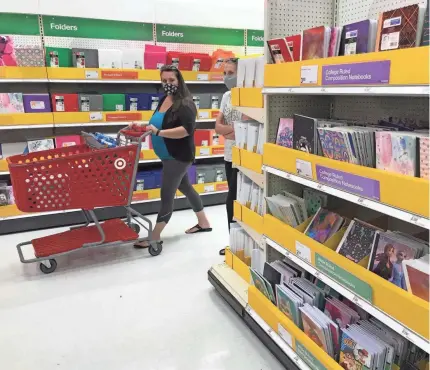  ?? USA TODAY NETWORK ?? Shoppers peruse back-to-school items at Target in Menomonee Falls, Wis. “It’s the most challengin­g time in history for back-to-school,” said Burt P. Flickinger III, of Strategic Resource Group, a consumer consulting firm.