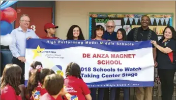  ??  ?? FROM LEFT: LeDoux, a group of De Anza Magnet School students, ECESD Board of Directors George McFaddin, Michael Minnix and Ambriz hold a banner during a school assembly Wednesday in El Centro. VINCENT OSUNA PHOTO