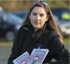  ?? Emma Larkin with her intercount­y editions of Izzy’s Magical Football Adventure. Photo by Domnick Walsh ??