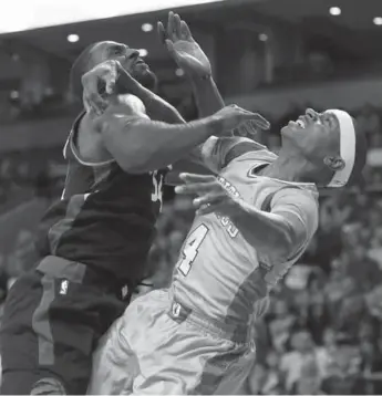  ?? MICHAEL DWYER/THE ASSOCIATED PRESS ?? Toronto had hugs for Amir Johnson, but Patrick Patterson, left, was a little rougher with Boston’s Isaiah Thomas.