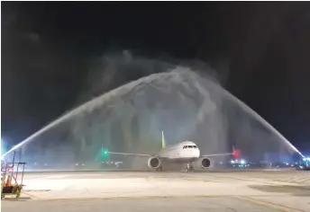  ?? ?? The Royal Brunei Airlines aircraft given a ceremonial water salute on arrival at Kuching Internatio­nal Airport on Sunday night.