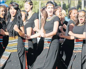  ??  ?? HAPPY TIME: NMMU choir members, above, celebrate the varsity’s 10th birthday, while, right, dancers Kelly Adams, Danica Govin and Allissa Matroos interpret the significan­ce of the occasion