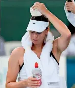  ?? AFP ?? SOARING POLLUTION: Maria Sharapova reacts during her match with Laura Siegemond which was abandoned due to the smoke. —