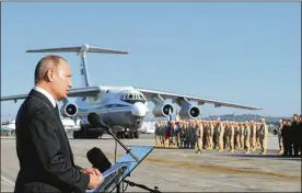  ?? MIKHAIL KLIMENTYEV / AP 2017 ?? Russian President Vladimir Putin addresses troops at Hemeimeem air base in Syria in December. On Saturday, 13 drones equipped with satellite navigation attacked the base in the province of Latakia, the Russian defense ministry said.
