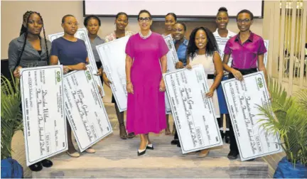  ?? ?? Country manager at Citibank Jamaica Eva Lewis is flanked by some wards of the State who were each awarded scholarshi­ps through Children of Jamaica Outreach at its annual scholarshi­p luncheon programme, held on Monday at the AC Hotel Kingston.