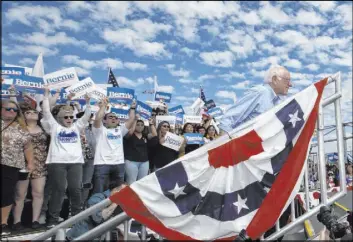  ?? Damian Dovarganes The Associated Press ?? Sen. Bernie Sanders of Vermont is cheered at a campaign event Friday at Valley High School in Santa Ana, Calif. California has 415 delegates at stake on Super Tuesday.