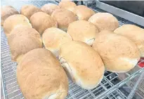  ?? ?? Loaves cool on racks in the Greener Village food bank kitchen.