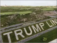  ?? JOHN MINCHILLO — THE ASSOCIATED PRESS ?? Patrons play the links as a giant branding sign is displayed with flagstones at Trump Golf Links at Ferry Point in the Bronx on Tuesday, May 4.