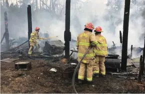  ?? (Submitted Photo) ?? Volunteer firefighte­rs extinguish a structure fire in Stugis.