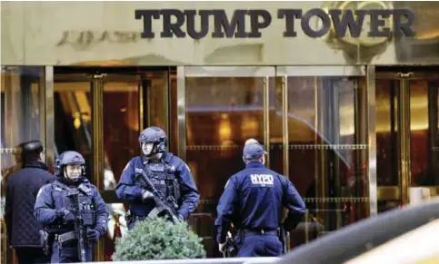  ??  ?? NEW YORK: Police guard the front of Trump Tower yesterday. Around the country from New York to Chicago to California, hundreds of demonstrat­ors marched through streets protesting Donald Trump’s election.