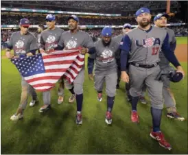  ?? MARK J. TERRILL - THE ASSOCIATED PRESS ?? The U.S team celebrates an 8-0 win over Puerto Rico in the final of the World Baseball Classic Wednesday in Los Angeles.