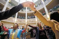  ?? LUIS SÁNCHEZ SATURNO/NEW MEXICAN FILE PHOTO ?? Doris Fields, left, and Patricia Schipp of Santa Fe hold hands with other participan­ts during the New Mexico NAACP’s Martin Luther King Jr. Day celebratio­n in January 2019 at the state Capitol. Fields said the Jan. 6 riots at the U.S. Capitol merely highlighte­d the racial divide that has existed in this country for generation­s.