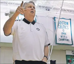 ?? AP PHOTO ?? Danny Ainge, Boston Celtics president of basketball operations, gestures as he passes the team’s NBA championsh­ip banners st the team’s training facility in Waltham, Mass. on May 16.